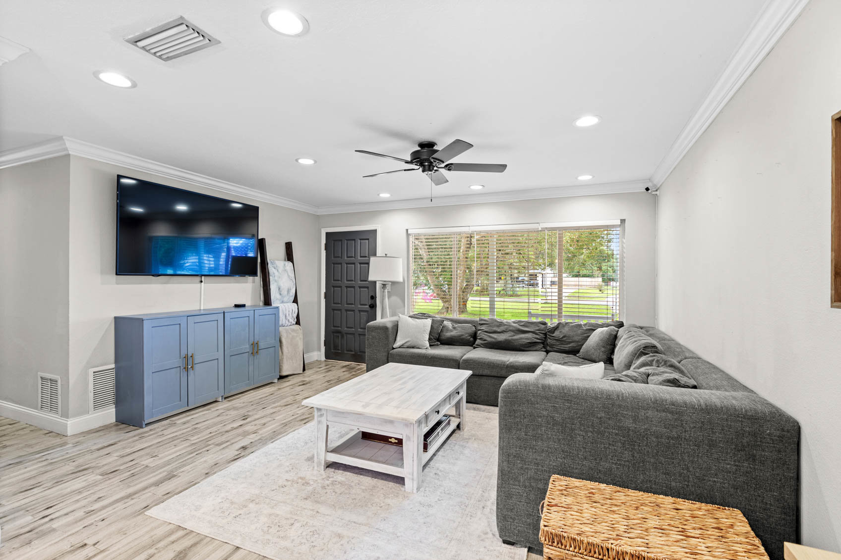 inside front door with living room sectional and mounted tv